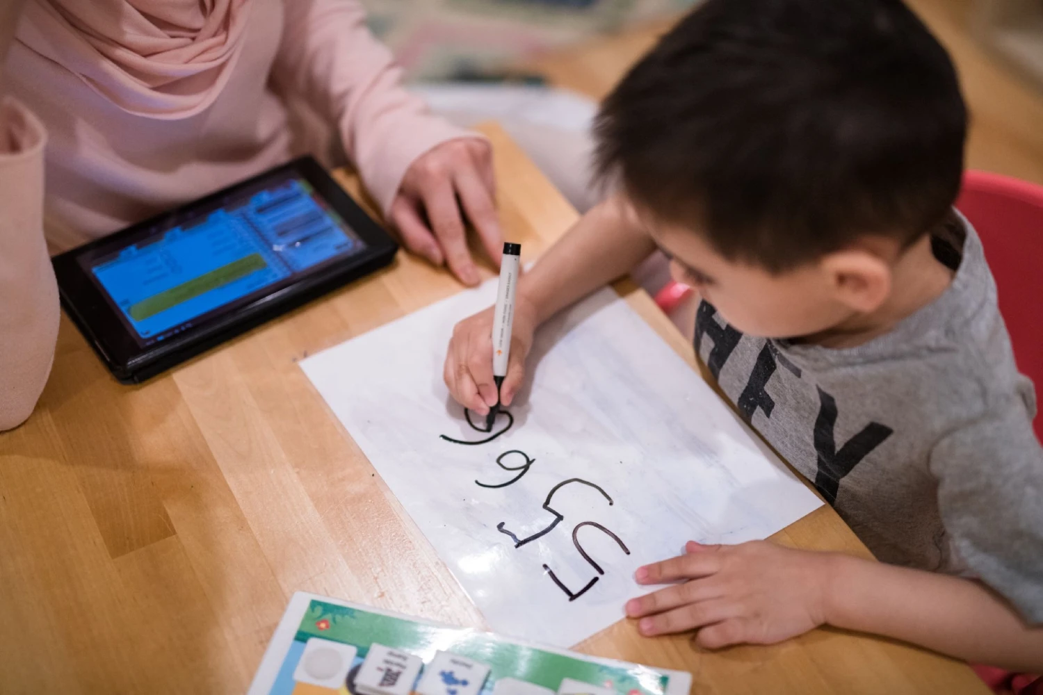 A CST Academy therapist tracking a child’s skills on a data tablet during a session
