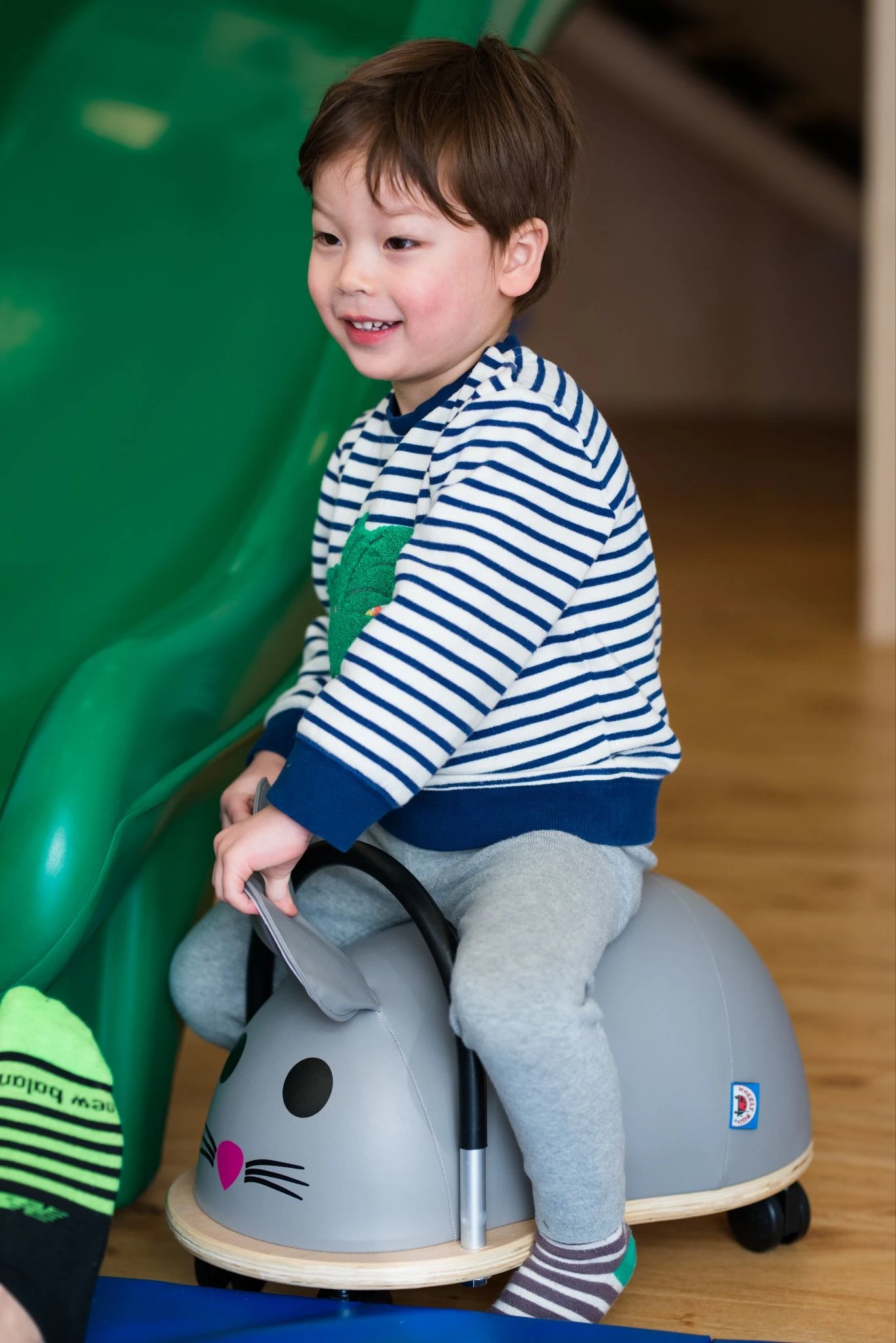 A smiling young child during a play-based session at CST Academy