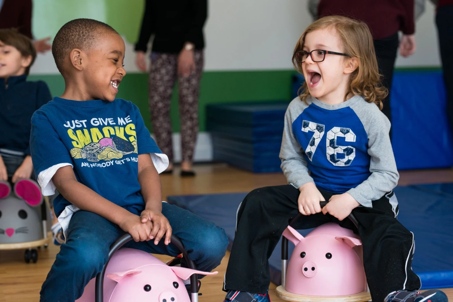 Two children laughing together during a session at CST Academy